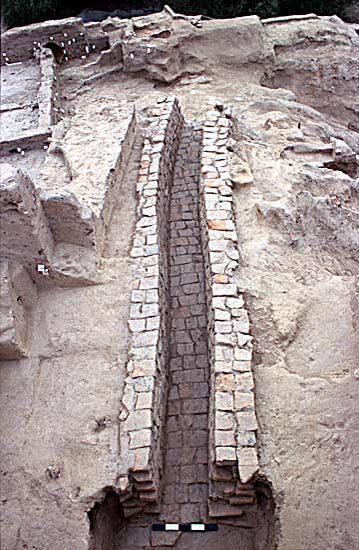 Brick robbing from both directions removed all but the central portion of this drain, but the remaining contents provide an important sequence of Harappan pottery spanning at least 200 years from 2400-2200 BC.