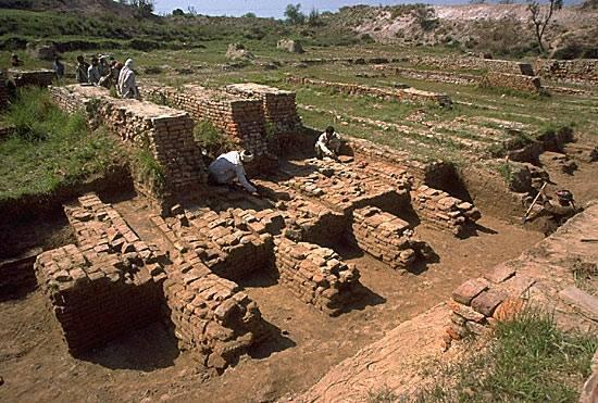 After clearing the overlying silt, the original forms of the baked brick walls and hollow buttresses of the "granary" could be made out. The three high walls in the upper left of the image are part of a later rebuilding of the entire structure after ca. 2200 BC.