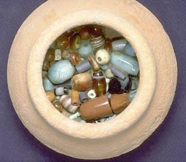 Initial probing to determine the contents of this small pot (169) from Trench 38, Late Harappan Period, revealed the presence of carnelian and faience beads. After removal of the overlying sediment it was clear that the pot was filled with beads. Each bead was mapped in and then photographed before removal. In the lower levels were many tiny beads that had settled to the bottom.