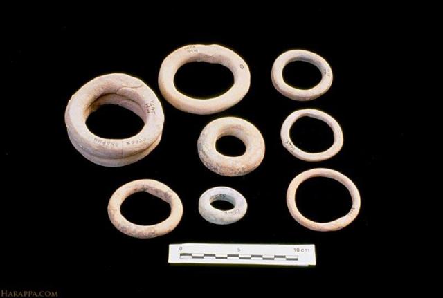Many of the terra cotta bangles were originally painted with black or red designs. Such ornaments are found in the thousands and may have been worn, broken and discarded much as glass bangles are used today throughout the subcontinent.