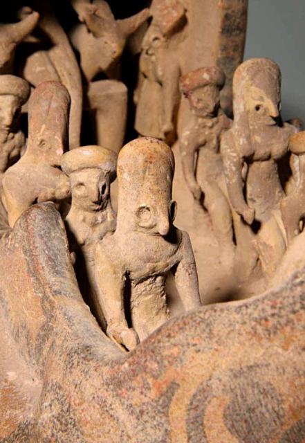 The first female figurine of the right side.