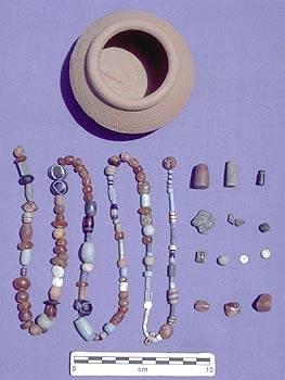 The small Late Harappan Period Pot yielded 133 beads & other decorative objects. Although left behind by a bead collector at almost 1700 BC, the wide variety of beads & other objects found inside the pot belong to all periods of Harappan occupation. In addition to carnelian & faience beads (the most numerous), the vessel contained what we first thought was a red-brown glass bead. Analysis conducted by Robert Brill (and colleagues) at Corning Museum of Glass determined it isn't glass, but crystalline rock.