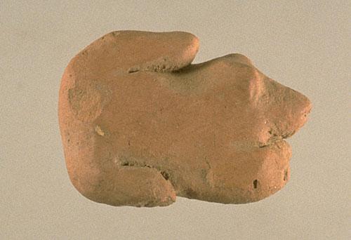 Dogs are also depicted in playful postures, such as one small dog that seems to be crouching with its tail curving up and onto its back. Approximate dimensions (W x H (L) x D): 1.9 x 3.3 x 2.1 cm. Photograph by Richard H. Meadow