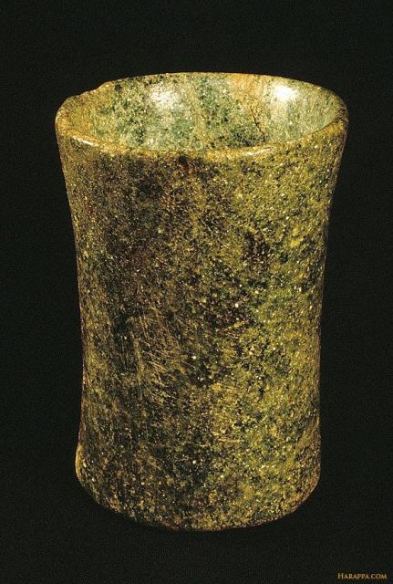 A drinking glass with finely polished exterior surface and sparkling internal crystal facet.