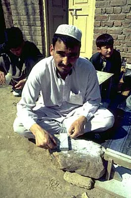 Mullah Ashur grinding beads