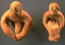 Most male figurines from Harappa sit with knees bent and arms at the sides of the legs or around the knees. Some of these figurines have facial features and even genitalia, and a few have stylized legs joined into a single projection.