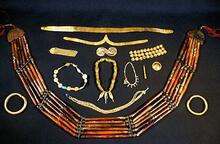 Indus jewelry made of gold, agate and carnelian. The gold filigrees at the top would have been worn around the head, at the bottom is a belt or necklace or carnelian.
