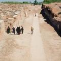 Looking north along First Street, Mohenjo-daro. "Only the facades of the eastern side of the street have been cleared, this being the limits decided upon for our excavations in this direction. Beyond this line, two-thirds of the mound, still remains untouched and will undoubtedly provide many buildings of interest for future excavations." (Mohenjo-daro, 1938, I, p. 25). The area to the left has been fully excavated and the area to the right is un-excavated. Later street levels are seen in the background.