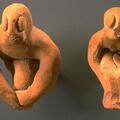 Most male figurines from Harappa sit with knees bent and arms at the sides of the legs or around the knees. Some of these figurines have facial features and even genitalia, and a few have stylized legs joined into a single projection.