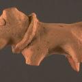 Some texts from ancient Mesopotamia mention imports received from the land of "Meluhha", widely considered a reference to the Indus Civilization. Among these imports, according to some interpretations, is a colored dog. A number of dog figurines have been found at Harappa and at other Indus sites. The collars found on dog figurines probably signify domestication, unlike the collars on the rhinoceros or the large feline figurines. Approximate dimensions (W x H(L) x D): 1.9 x 5.3 x 3.3 cm.