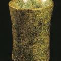 A drinking glass with finely polished exterior surface and sparkling internal crystal facet.